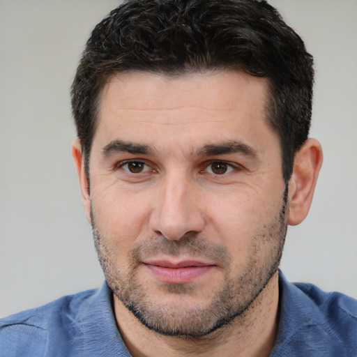 Joyful white young-adult male with short  black hair and brown eyes