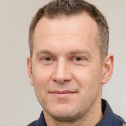 Joyful white adult male with short  brown hair and brown eyes