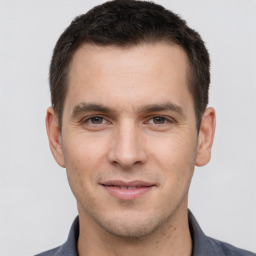 Joyful white young-adult male with short  brown hair and brown eyes