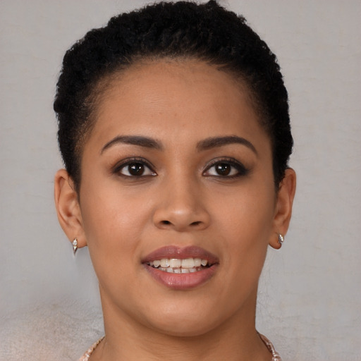 Joyful latino young-adult female with short  brown hair and brown eyes