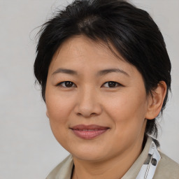 Joyful asian adult female with medium  brown hair and brown eyes