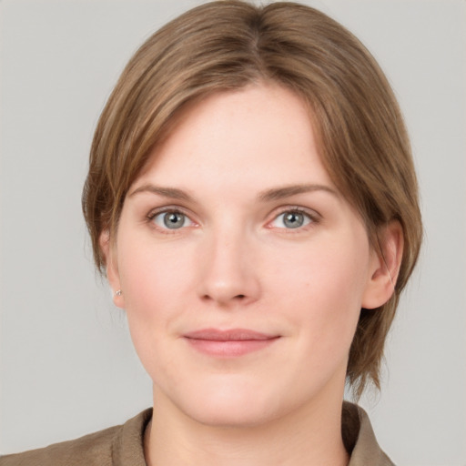 Joyful white young-adult female with medium  brown hair and grey eyes