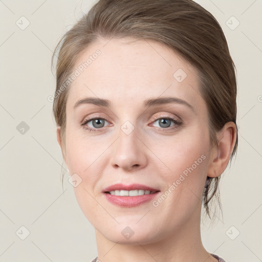 Joyful white young-adult female with medium  brown hair and green eyes