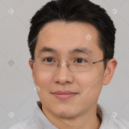 Joyful asian young-adult male with short  brown hair and brown eyes