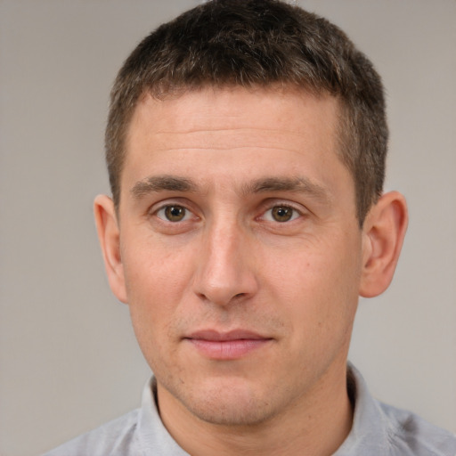 Joyful white adult male with short  brown hair and brown eyes