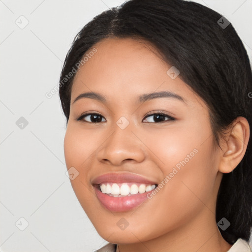 Joyful latino young-adult female with long  black hair and brown eyes