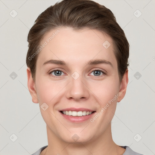 Joyful white young-adult female with short  brown hair and grey eyes