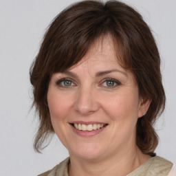 Joyful white adult female with medium  brown hair and grey eyes