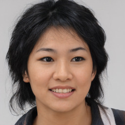 Joyful asian young-adult female with medium  black hair and brown eyes