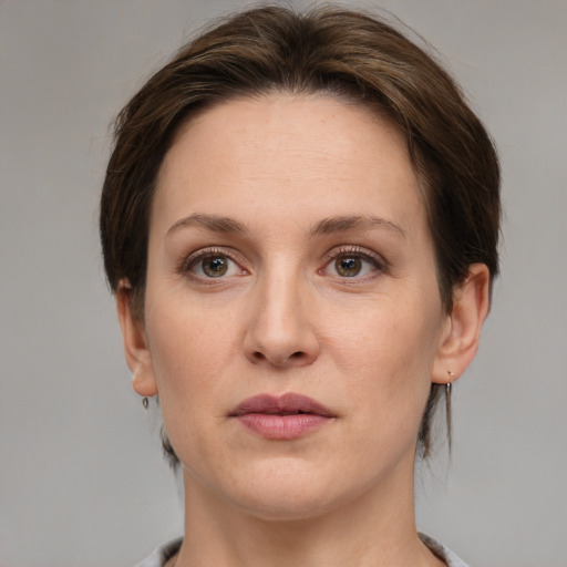 Joyful white adult female with medium  brown hair and grey eyes