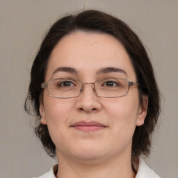 Joyful white adult female with medium  brown hair and brown eyes