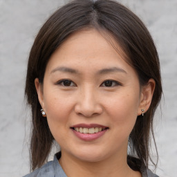 Joyful asian young-adult female with medium  brown hair and brown eyes