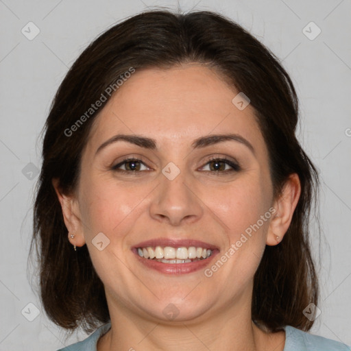 Joyful white adult female with medium  brown hair and brown eyes