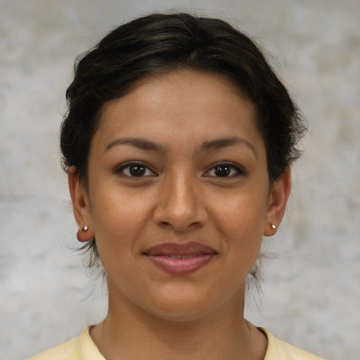 Joyful latino young-adult female with short  brown hair and brown eyes