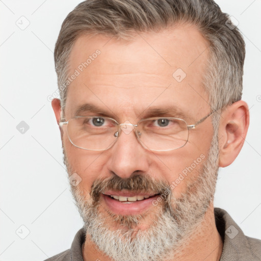 Joyful white middle-aged male with short  brown hair and brown eyes