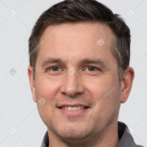 Joyful white adult male with short  brown hair and brown eyes