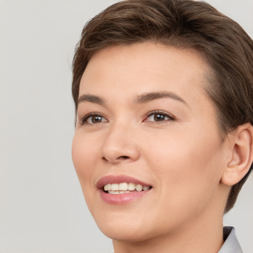 Joyful white young-adult female with short  brown hair and brown eyes