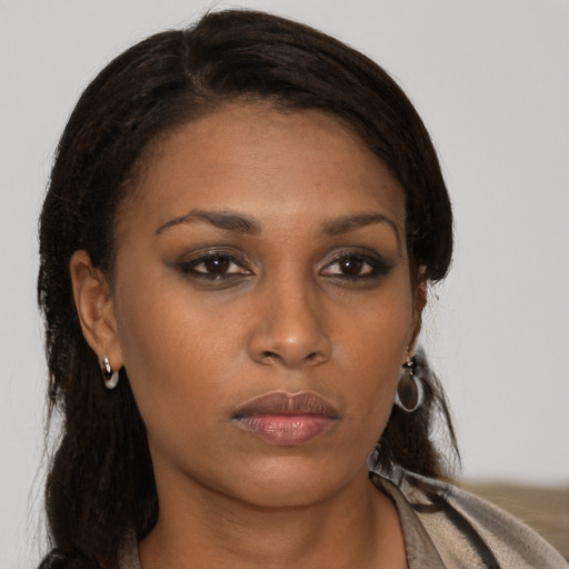 Neutral black young-adult female with medium  brown hair and brown eyes