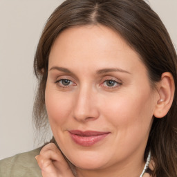 Joyful white adult female with medium  brown hair and grey eyes