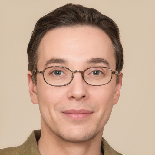 Joyful white young-adult male with short  brown hair and grey eyes