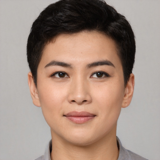 Joyful asian young-adult female with short  brown hair and brown eyes