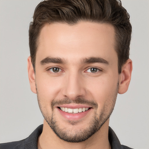 Joyful white young-adult male with short  brown hair and brown eyes