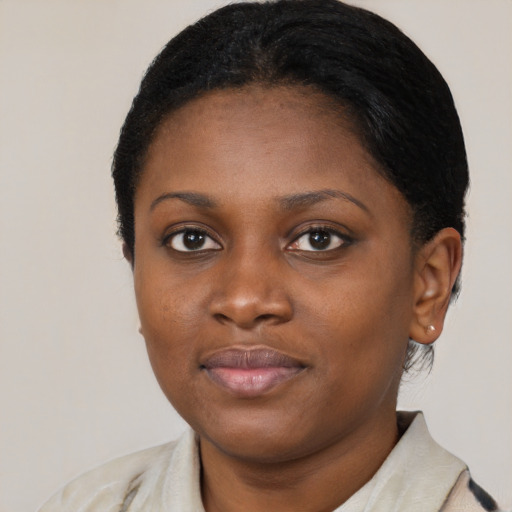 Joyful black young-adult female with medium  black hair and brown eyes