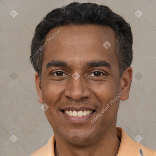 Joyful latino adult male with short  black hair and brown eyes