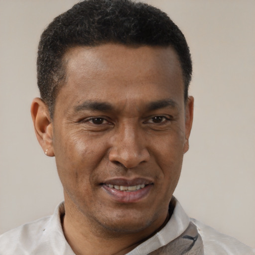 Joyful latino adult male with short  brown hair and brown eyes
