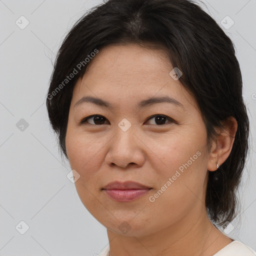 Joyful asian adult female with medium  brown hair and brown eyes