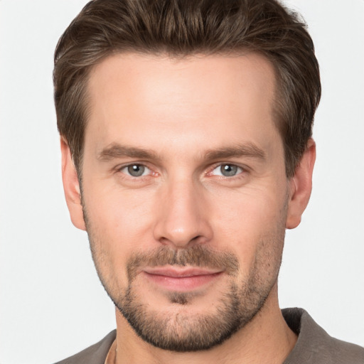 Joyful white young-adult male with short  brown hair and brown eyes