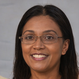 Joyful white adult female with long  brown hair and brown eyes