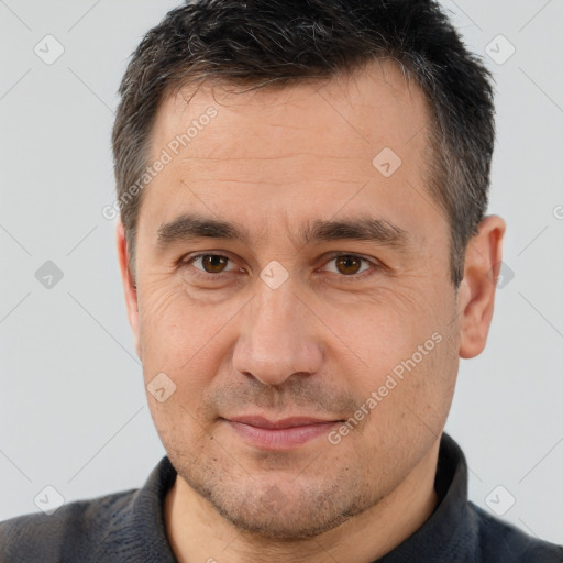 Joyful white adult male with short  brown hair and brown eyes