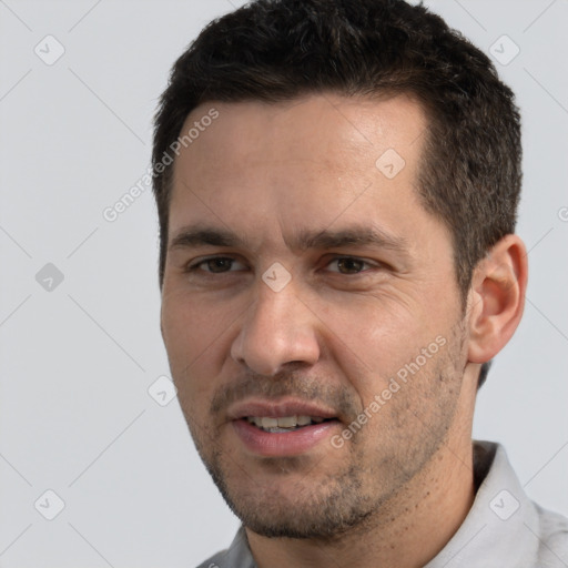 Joyful white adult male with short  black hair and brown eyes