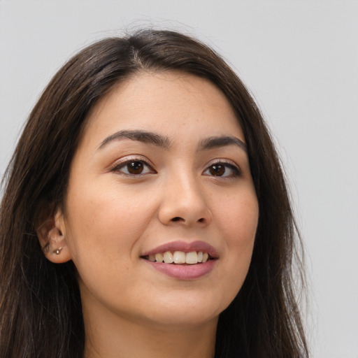 Joyful white young-adult female with long  brown hair and brown eyes