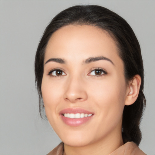 Joyful white young-adult female with medium  black hair and brown eyes