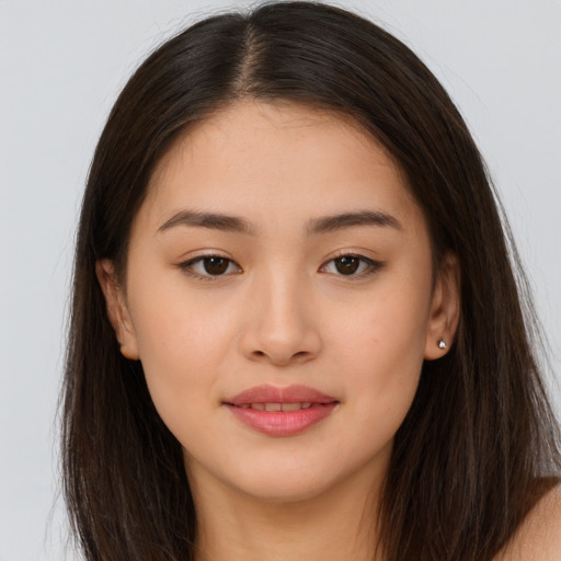 Joyful asian young-adult female with long  brown hair and brown eyes