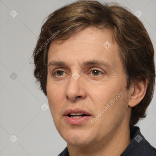 Joyful white adult male with medium  brown hair and brown eyes