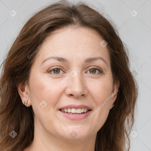 Joyful white adult female with long  brown hair and green eyes