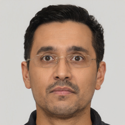 Neutral latino adult male with short  black hair and brown eyes