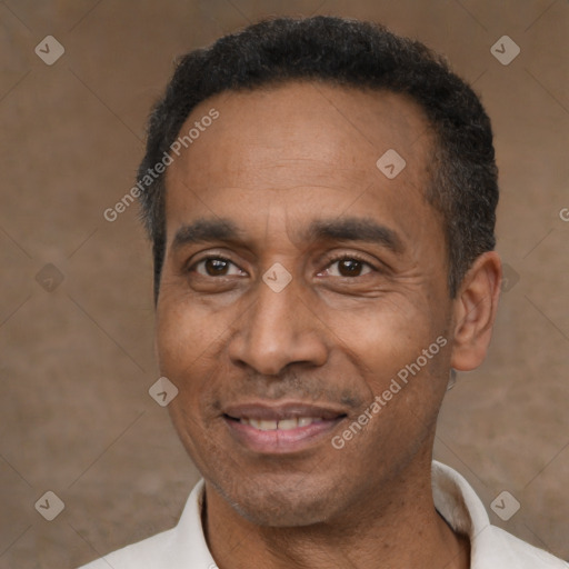 Joyful latino adult male with short  black hair and brown eyes