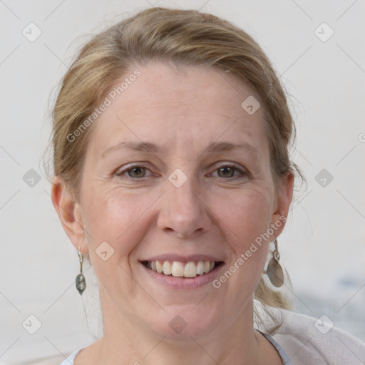 Joyful white adult female with medium  brown hair and grey eyes