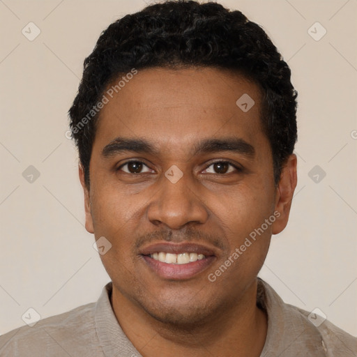 Joyful black young-adult male with short  black hair and brown eyes