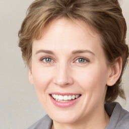 Joyful white young-adult female with medium  brown hair and blue eyes