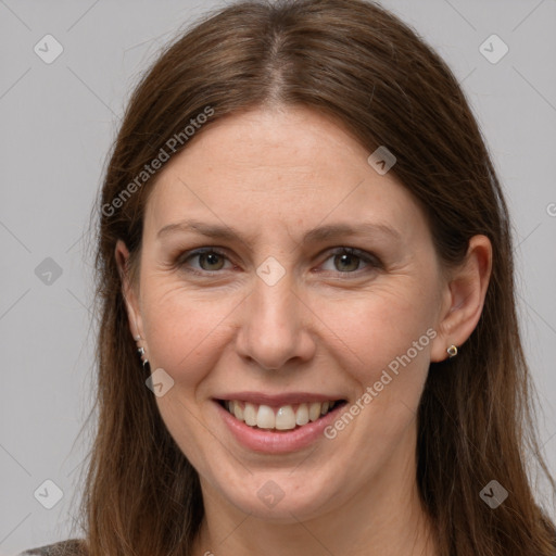 Joyful white adult female with long  brown hair and grey eyes