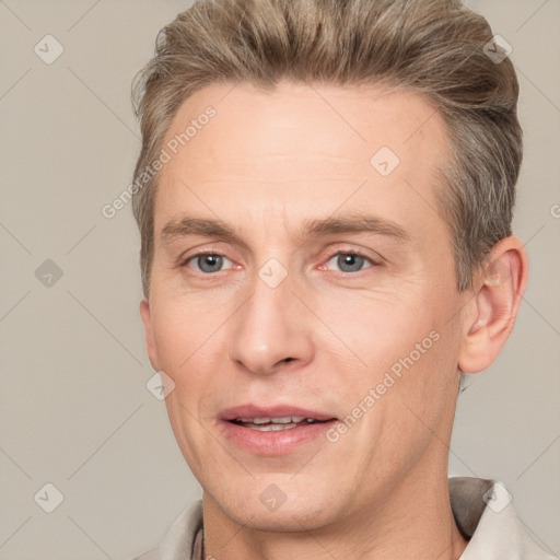 Joyful white adult male with short  brown hair and grey eyes