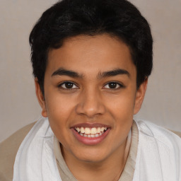 Joyful latino young-adult male with short  brown hair and brown eyes