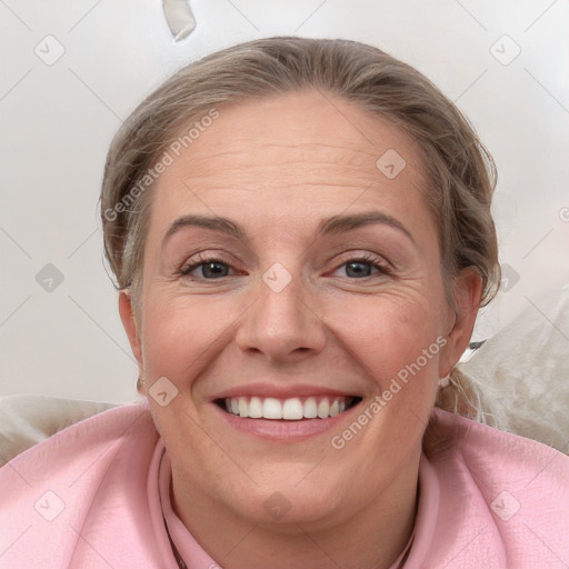 Joyful white adult female with medium  brown hair and blue eyes