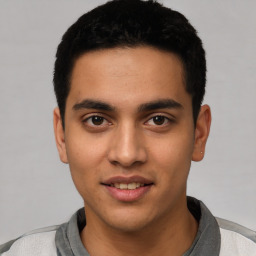 Joyful latino young-adult male with short  black hair and brown eyes