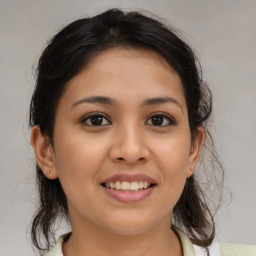 Joyful latino young-adult female with medium  brown hair and brown eyes